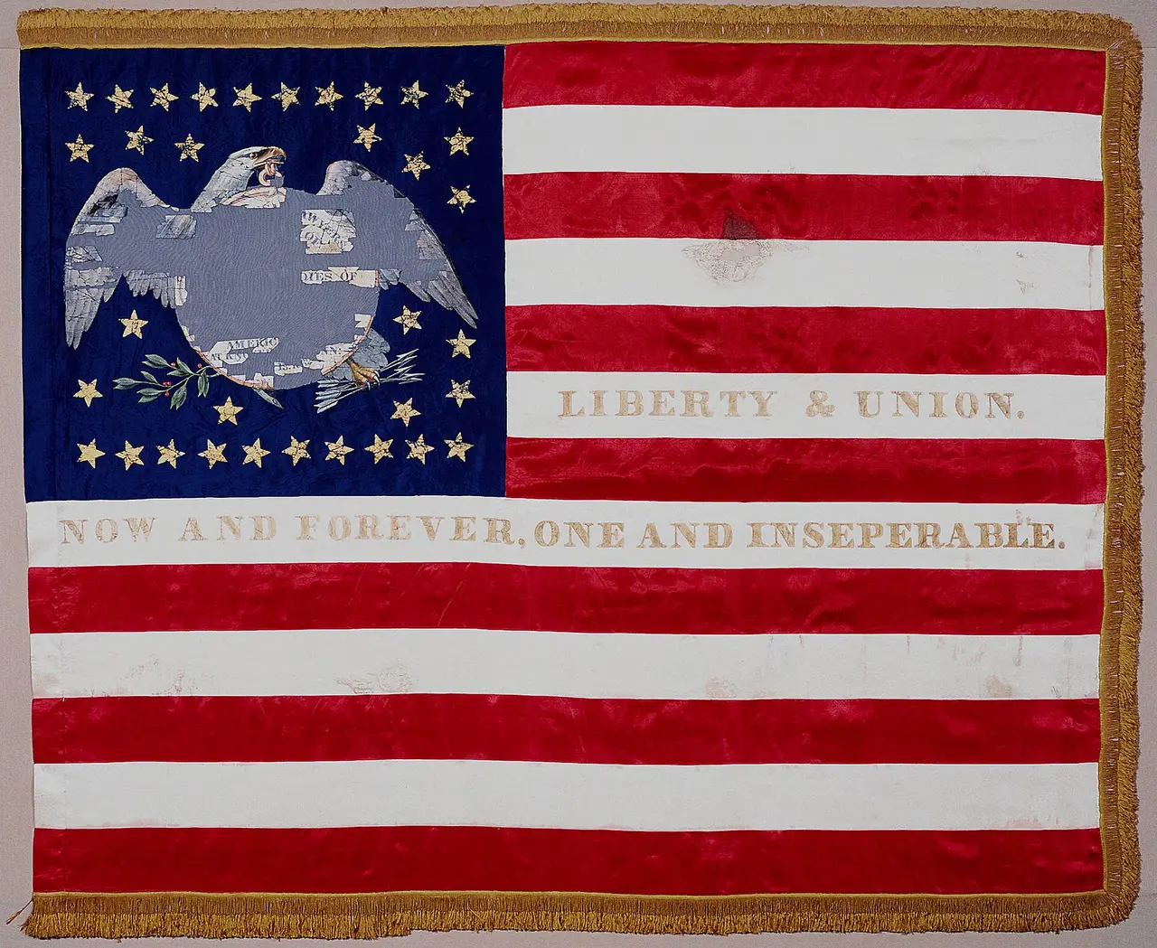 An American flag with an eagle and stars in the blue corner and red and white stripes