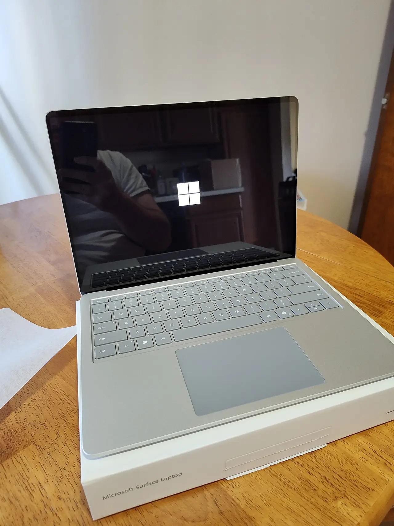 An open silver laptop on a wooden table