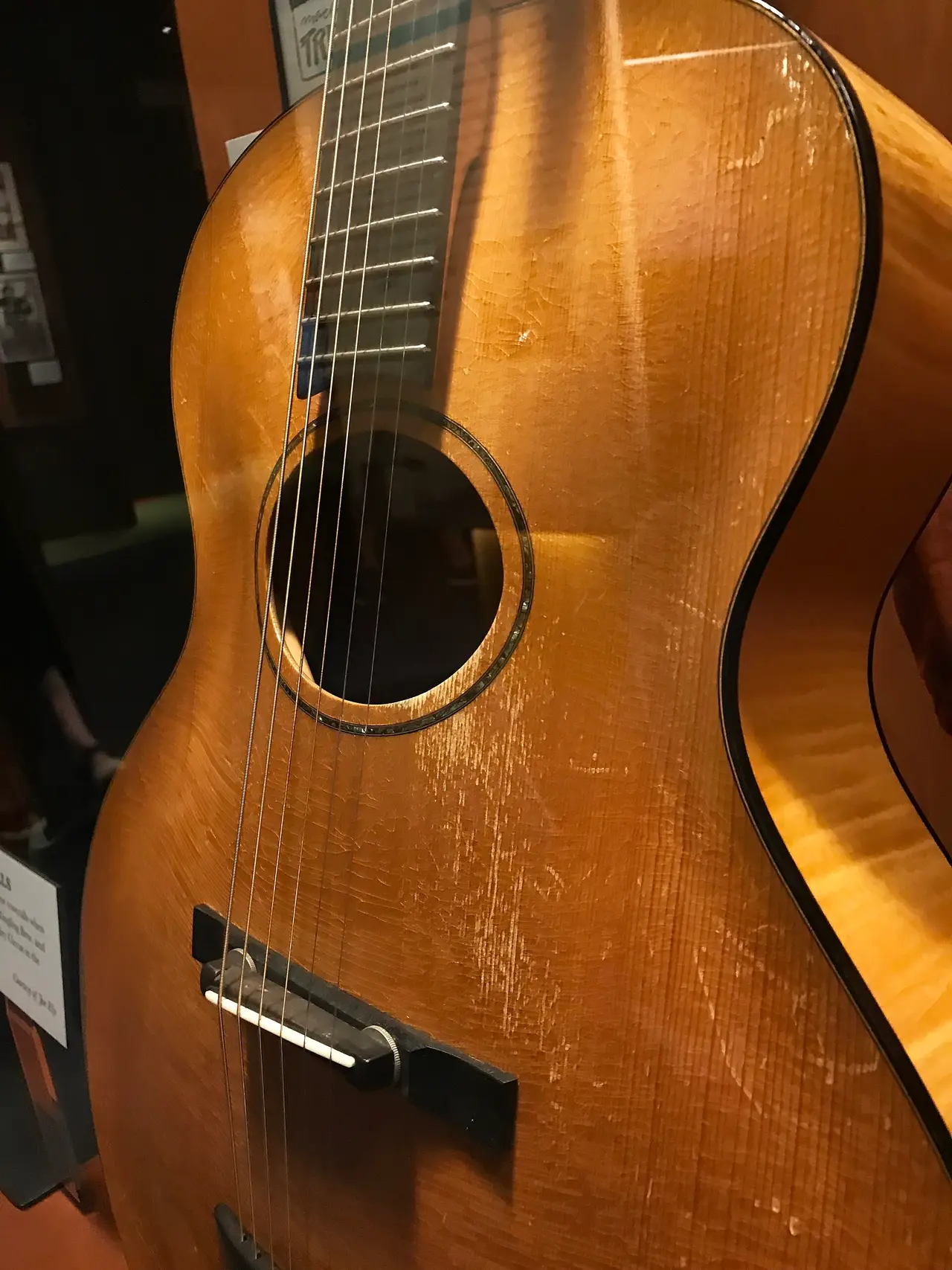 Archtop guitar with a jacket displayed in a museum case
