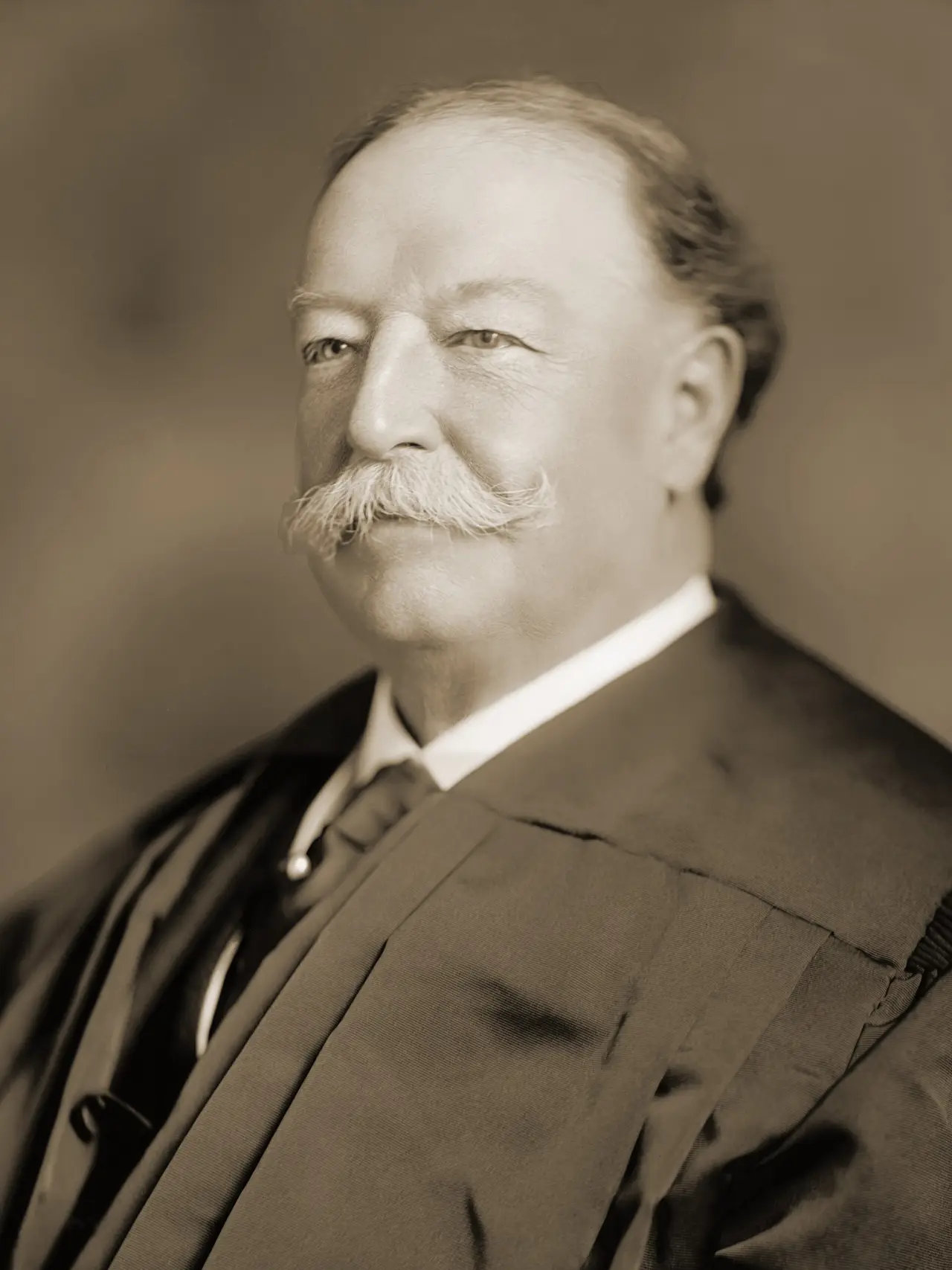 Portrait of a moustached man in a black judge's robe