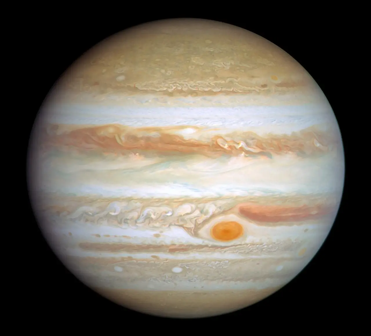 Banded planet Jupiter with its Great Red Spot against black space
