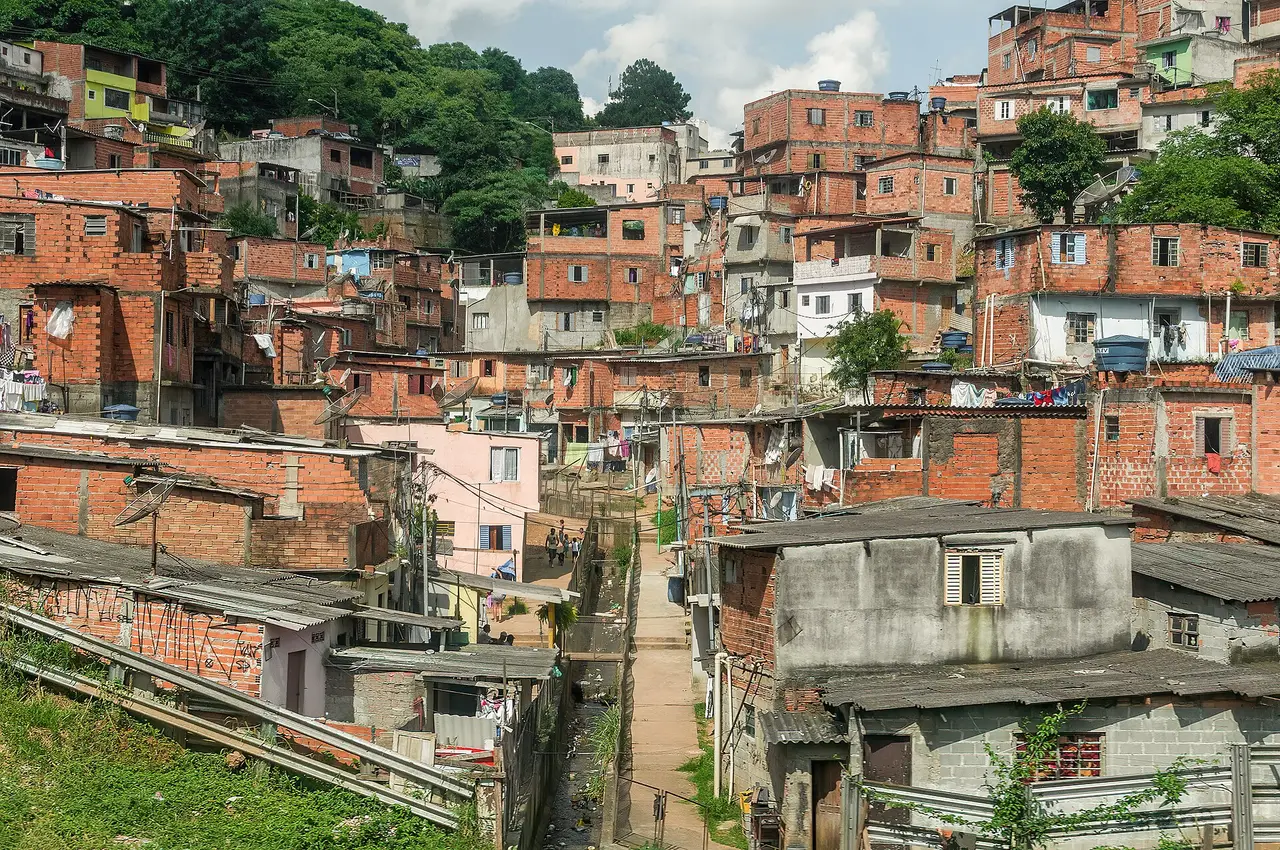 Brick houses crowded on a hillside in a São Paulo settlement