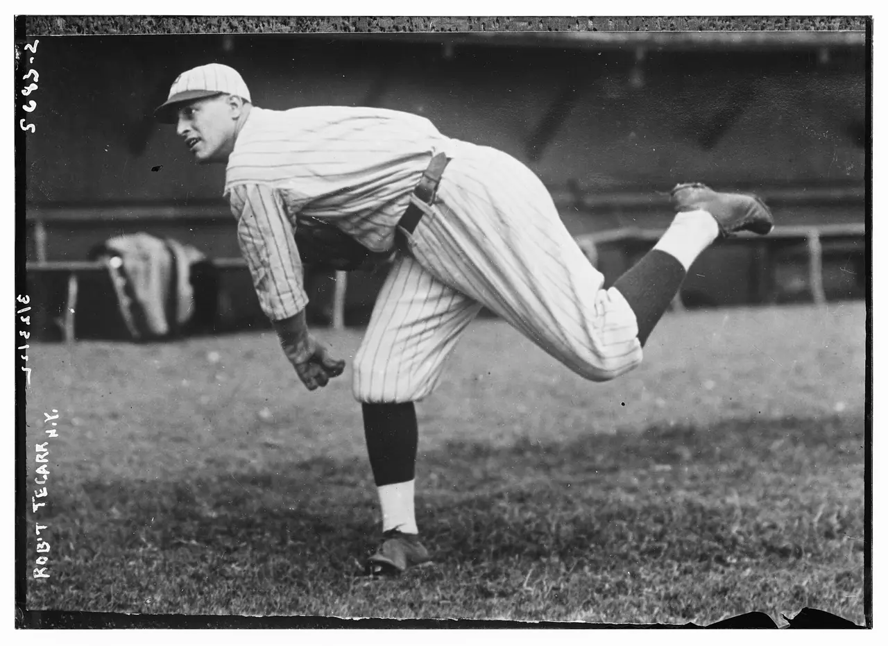 Black and white photo of a pitcher throwing a baseball