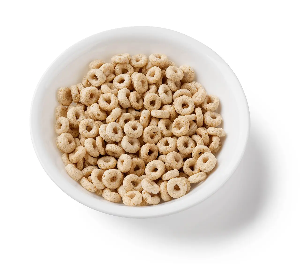 A white bowl of small ring-shaped cereal on a white background