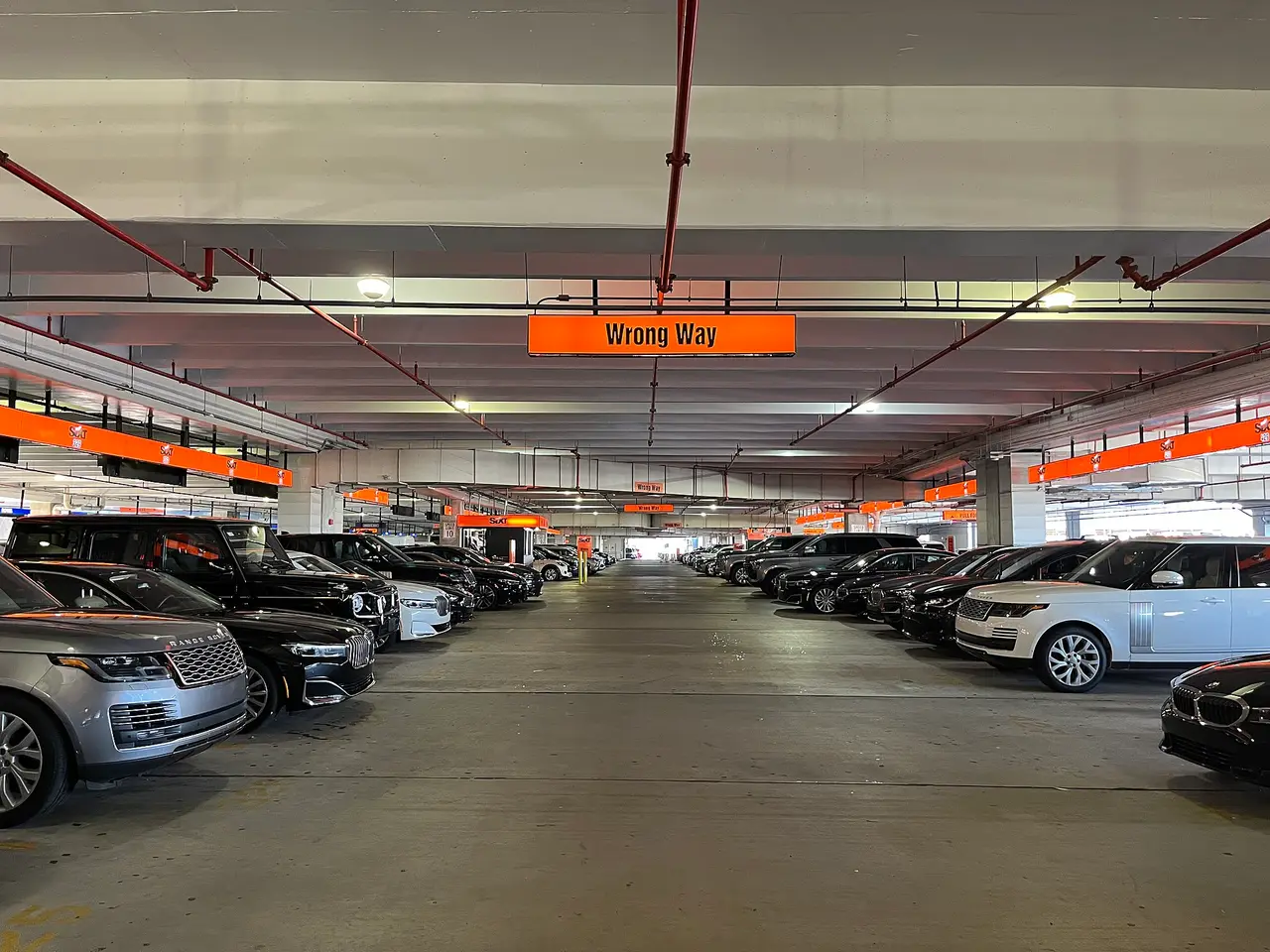 Cars parked in rows inside a covered garage