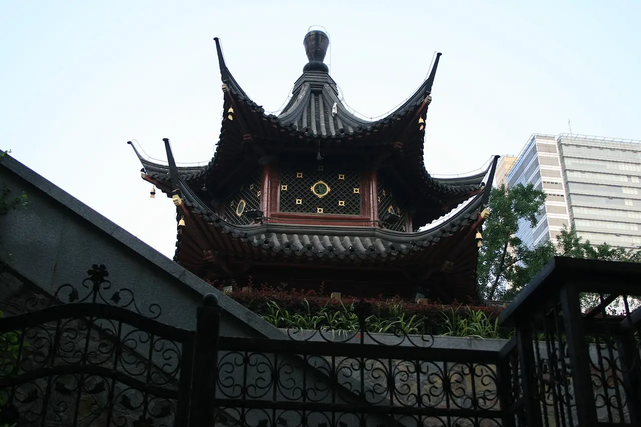 A dark tiered pagoda-style tower in Nanjing against the sky