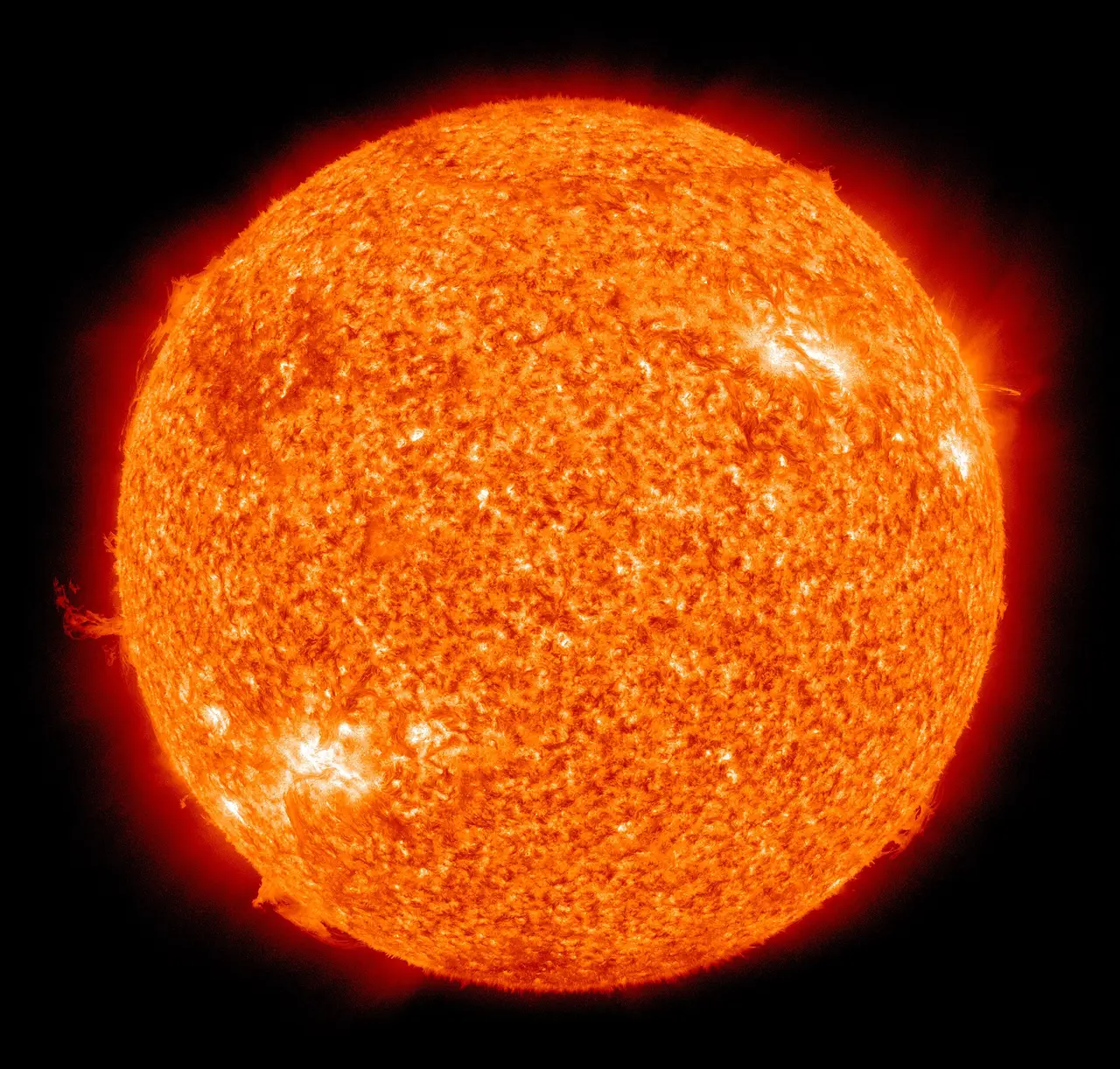 The Sun as an orange sphere with bright flares at its edge