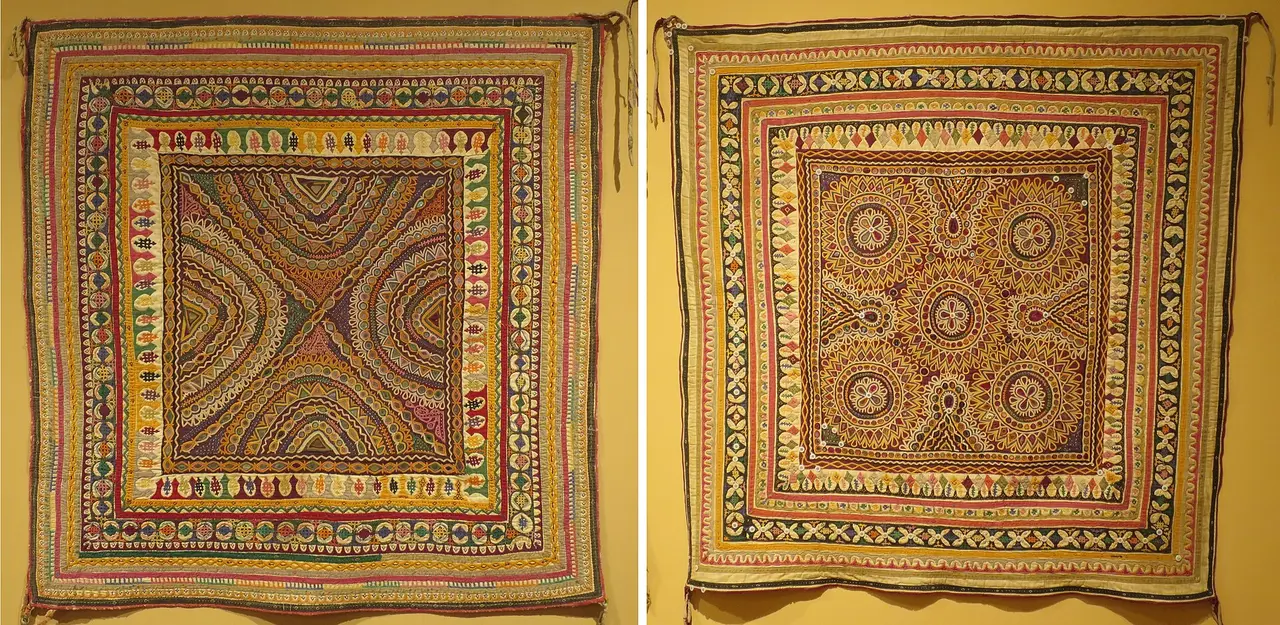 Two square embroidered cloth baby carriers with mirror work