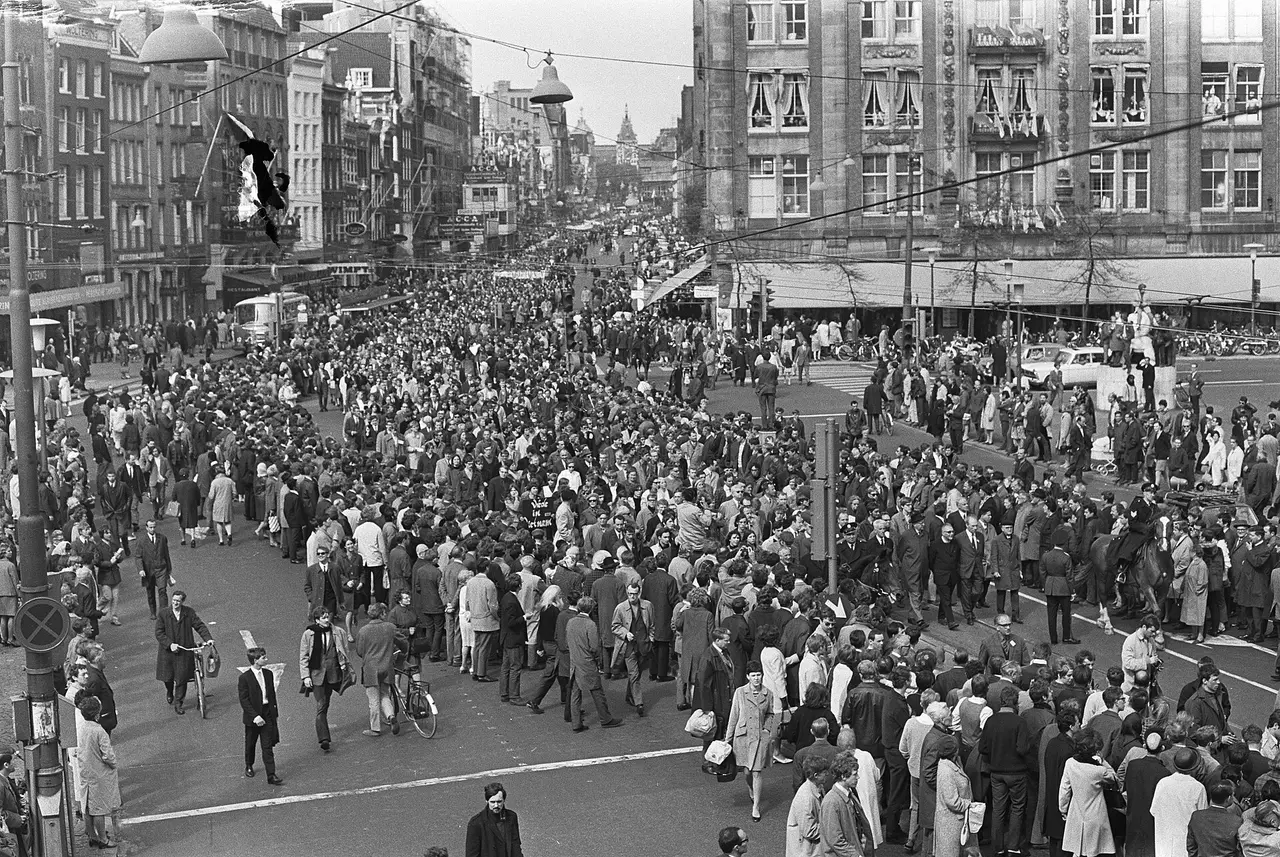 A dense crowd of demonstrators in a city street seen from above
