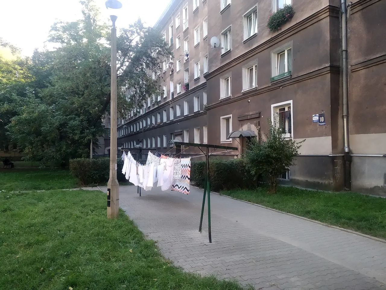 Washing hanging on a clothes line beside a block of flats