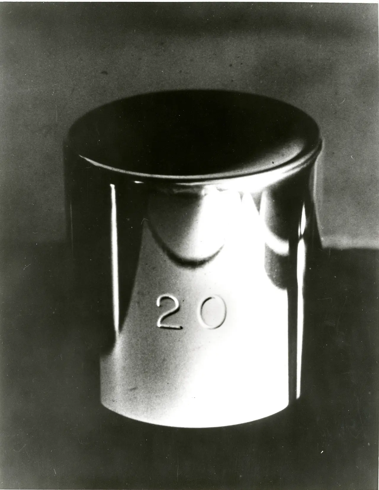 Black and white photo of a metal cylinder marked 20, the kilogram prototype