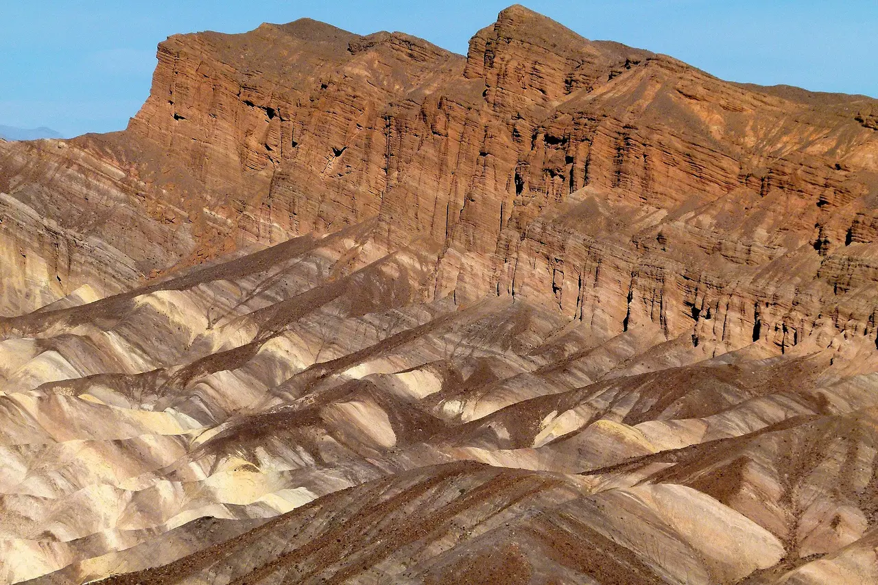 Banded orange and brown rock layers on a ridge