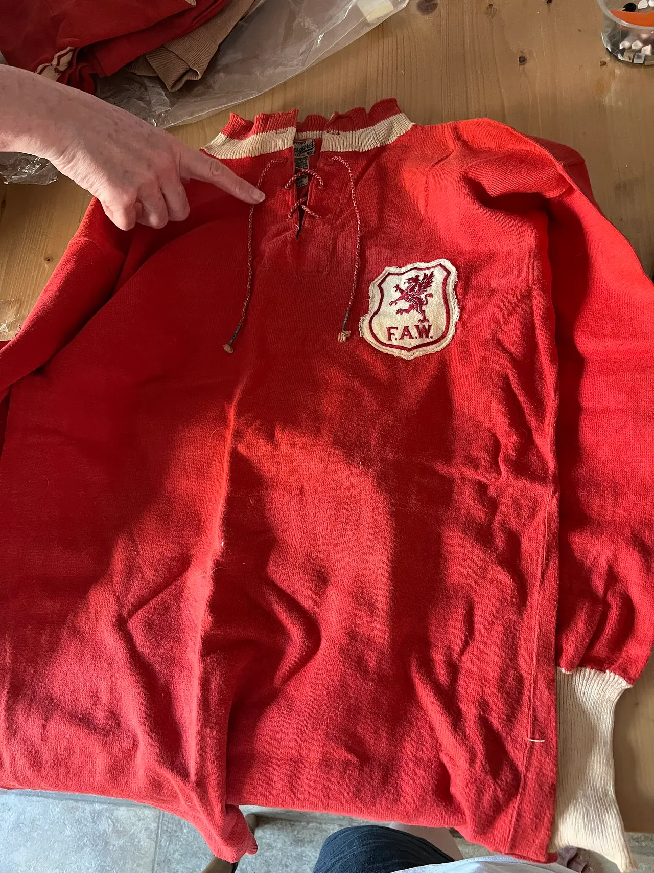 A red lace-collar football shirt laid flat