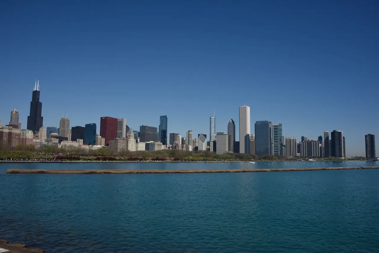 Chicago's tall towers along the horizon above blue water