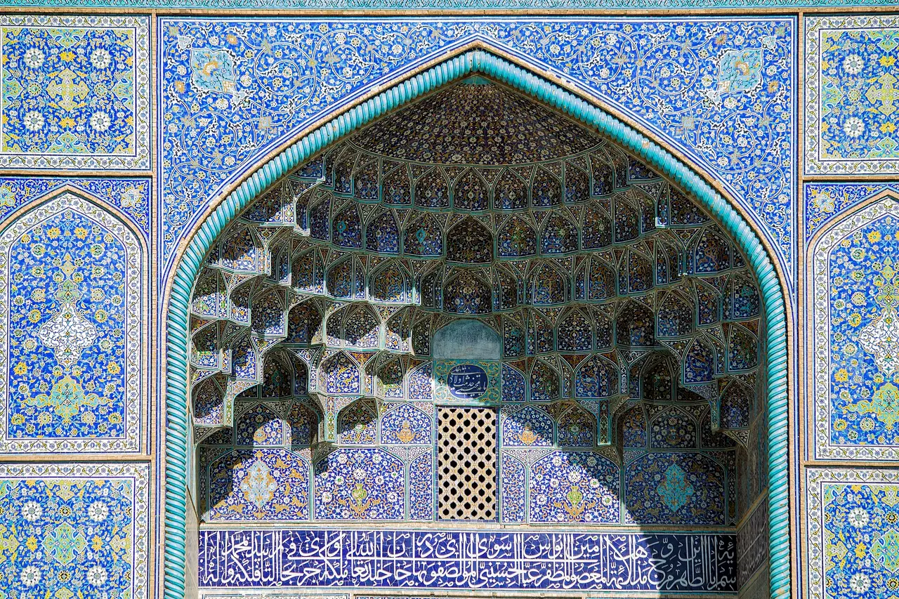 A blue-tiled arched portal with a honeycomb vault