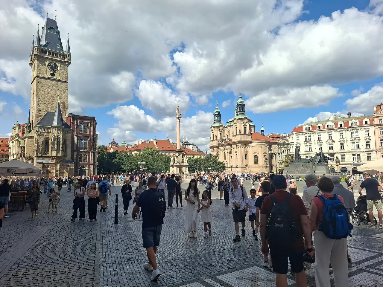 Crowds on Old Town Square in Prague with the town hall tower behind