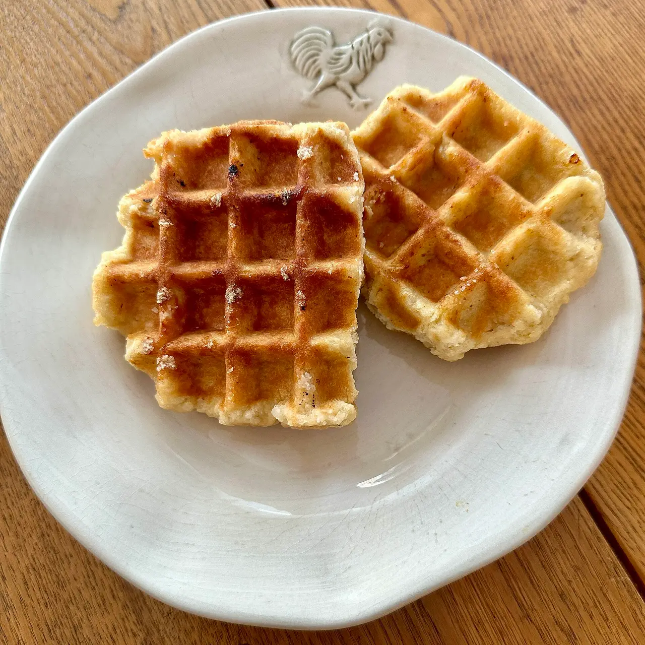 Two golden Liège waffles on a white plate