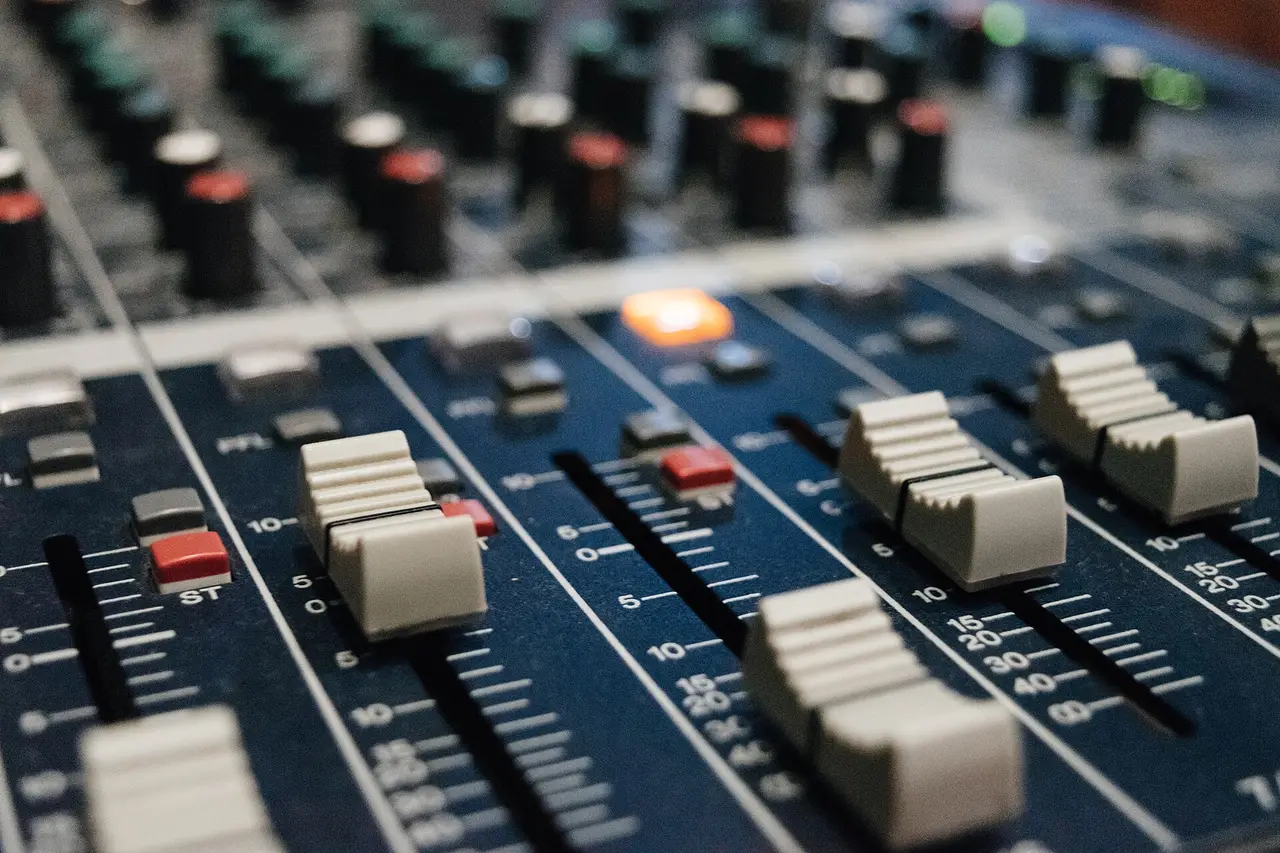 Close-up of faders and knobs on a mixing desk