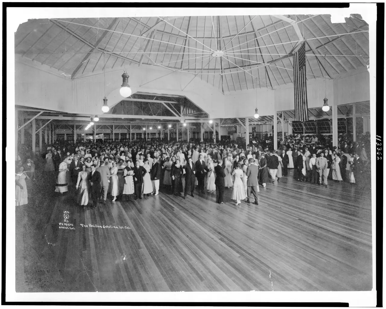 Couples dancing on a large wooden dance floor