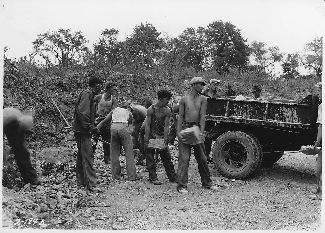 Men quarrying lime rock in an open pit
