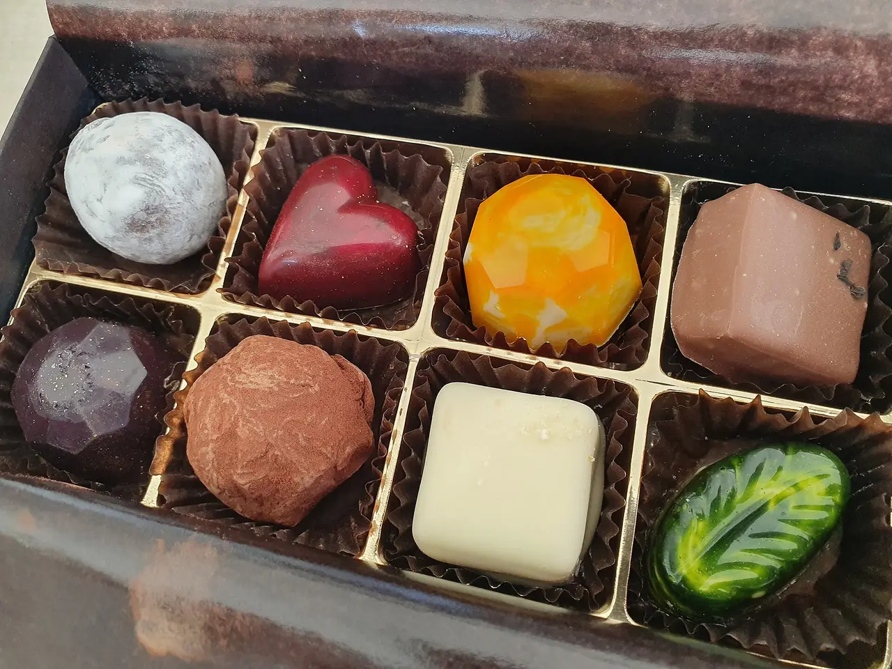 Box of colourful moulded chocolates in paper cases