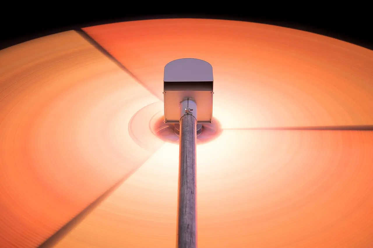 Turntable stylus on a spinning orange vinyl record