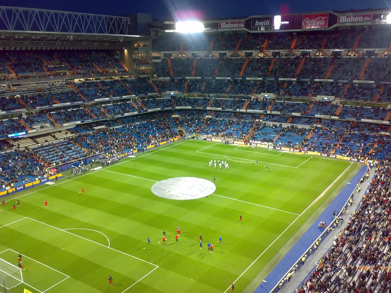 The pitch and stands of a large football stadium at night