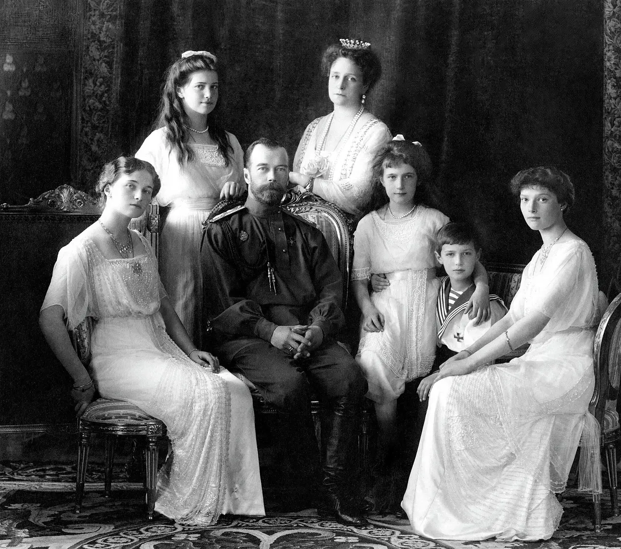 Black-and-white portrait of a seated royal family with five children