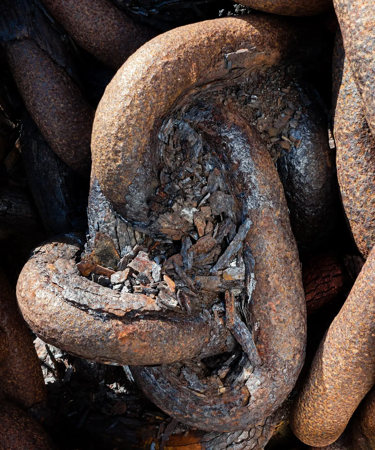 Heavy rusty chain links lying in a crate