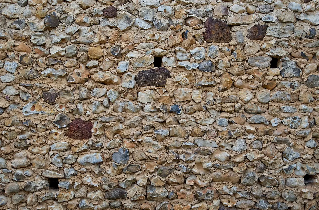 Close view of an old wall built from small stones