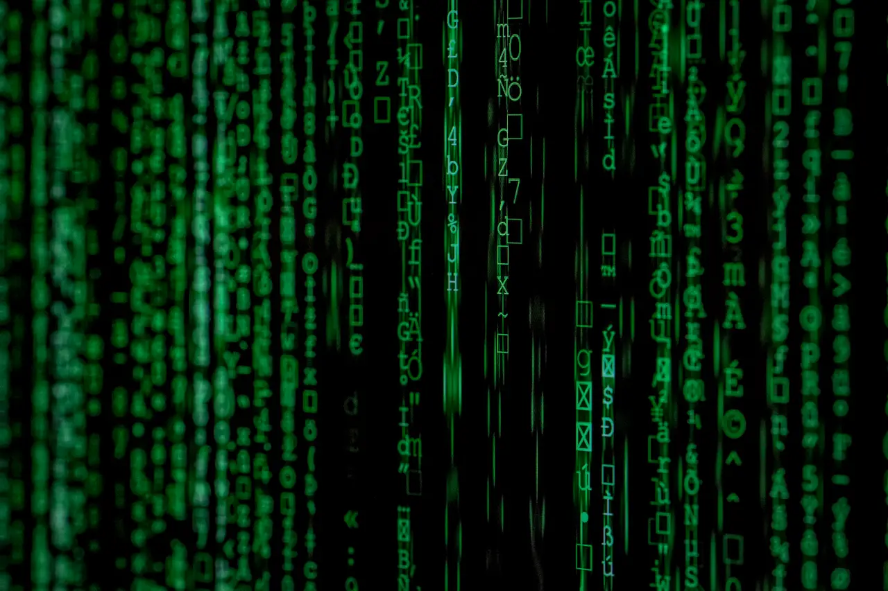 Columns of green characters falling down a dark screen