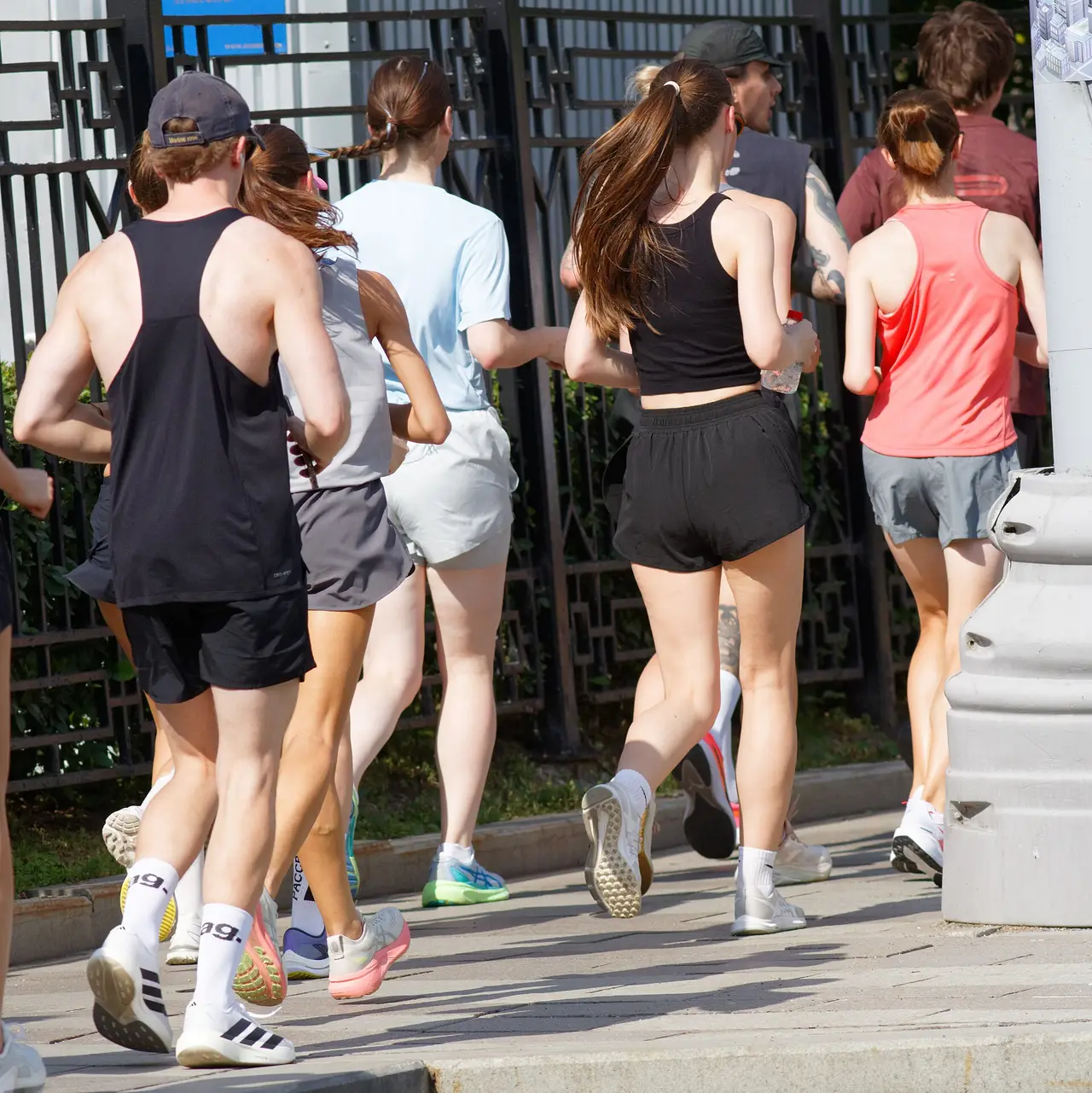 A group of runners seen from behind on a city road