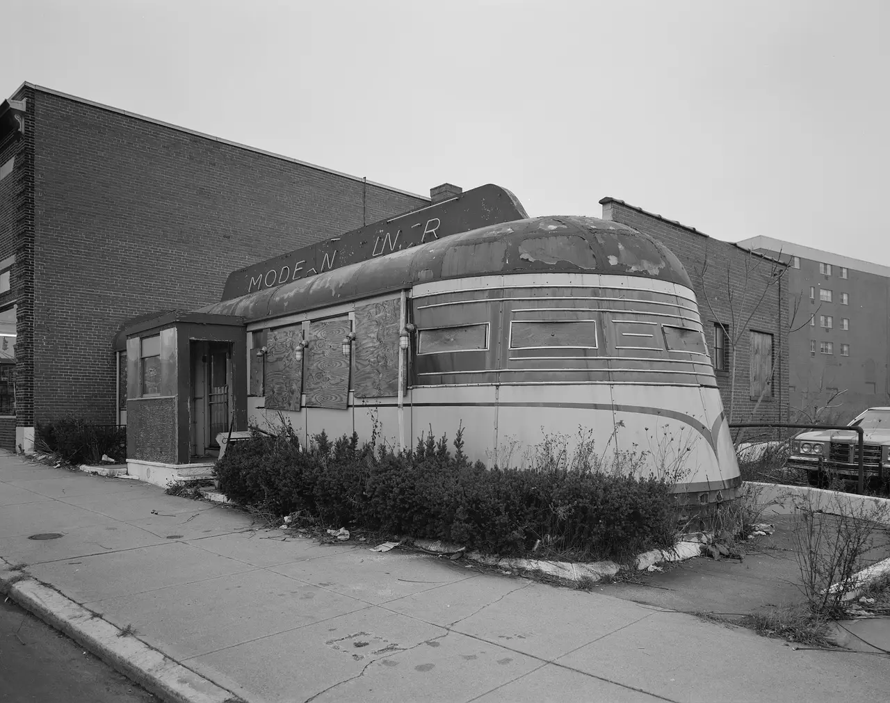 A streamlined diner building with a curved roof on a street corner