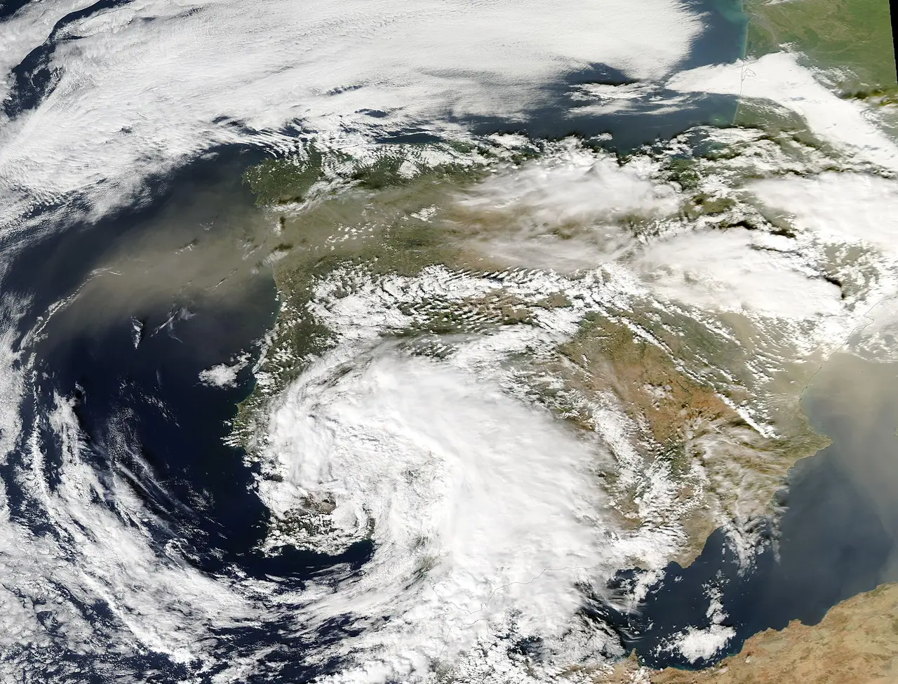 Satellite view of a spiral of white cloud over Spain and the western Mediterranean