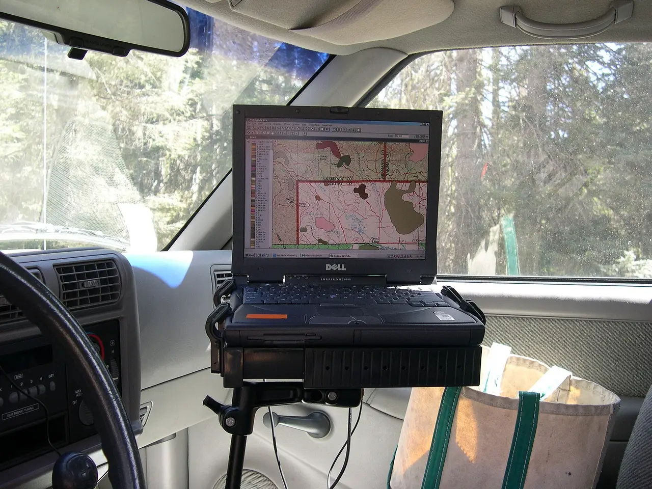 A laptop in a truck cab displaying a survey map