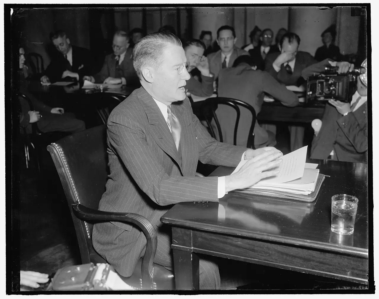 Man in a suit speaking at a table before a Senate committee