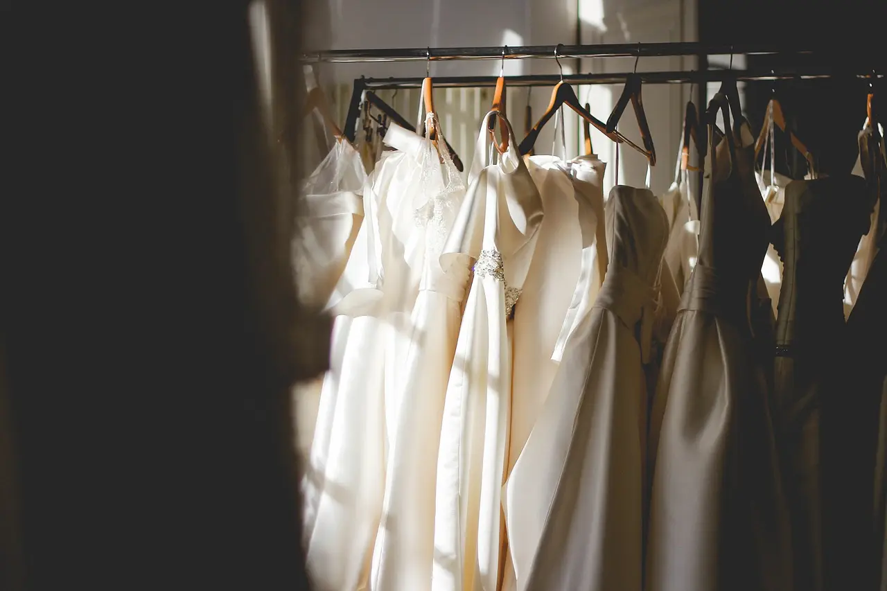 White and cream dresses hanging on a clothes rail