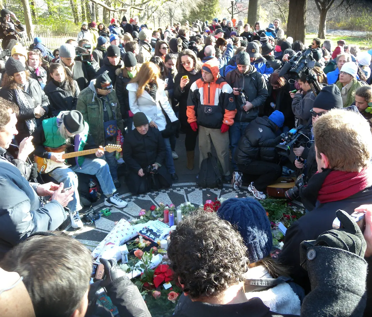 A crowd gathered at Strawberry Fields in Central Park