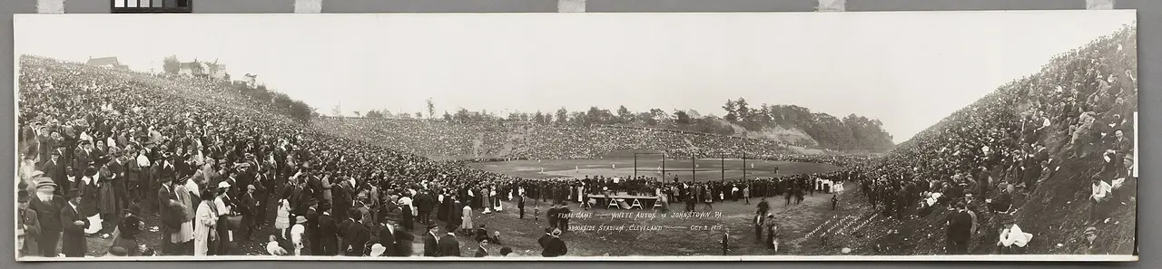 Panoramic old photograph of a packed stadium and playing field