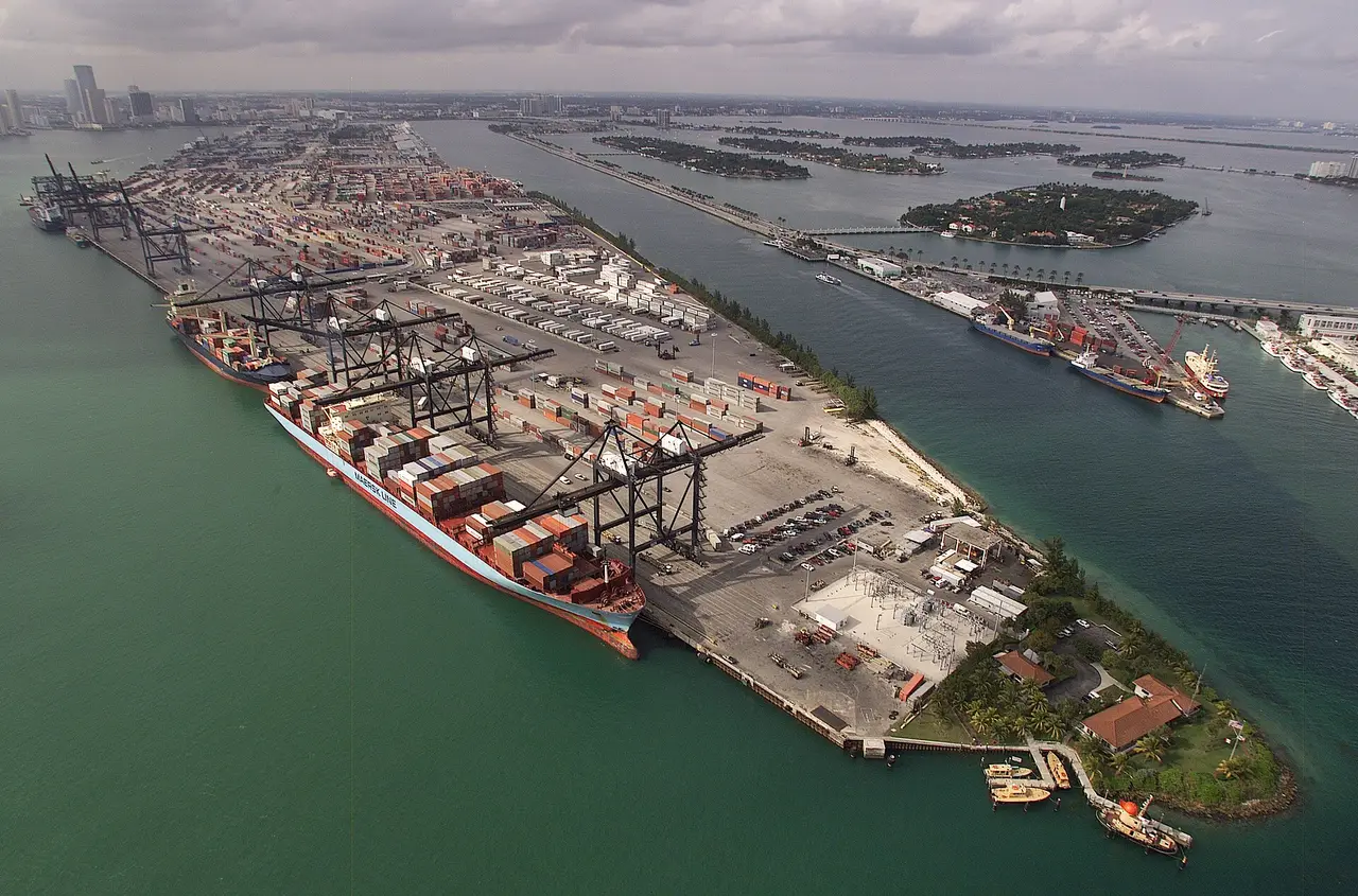 Container ships and stacked containers seen from the air at a port