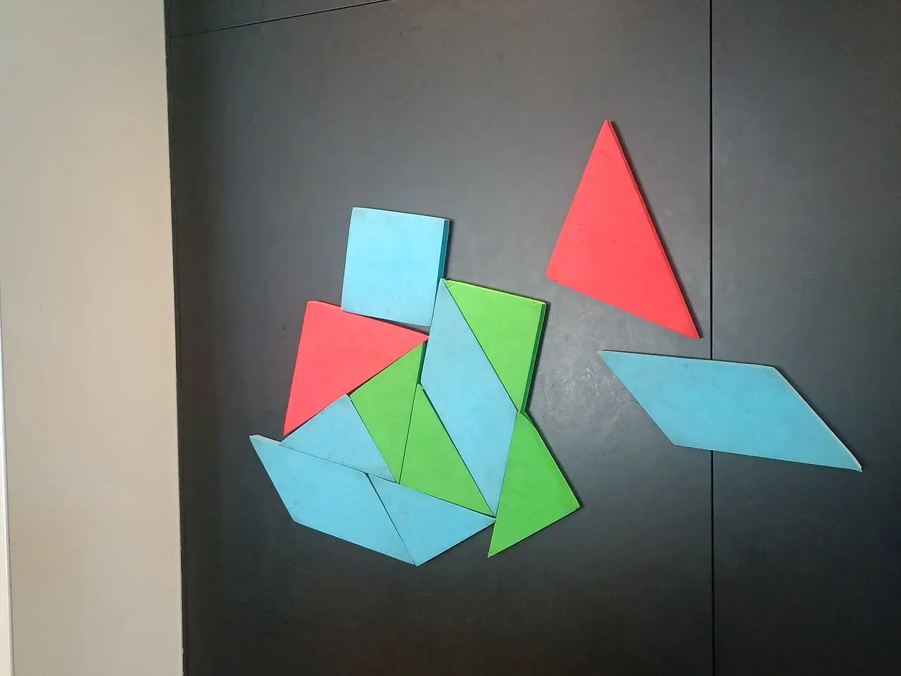 Triangles and a parallelogram in red, blue and green on a board