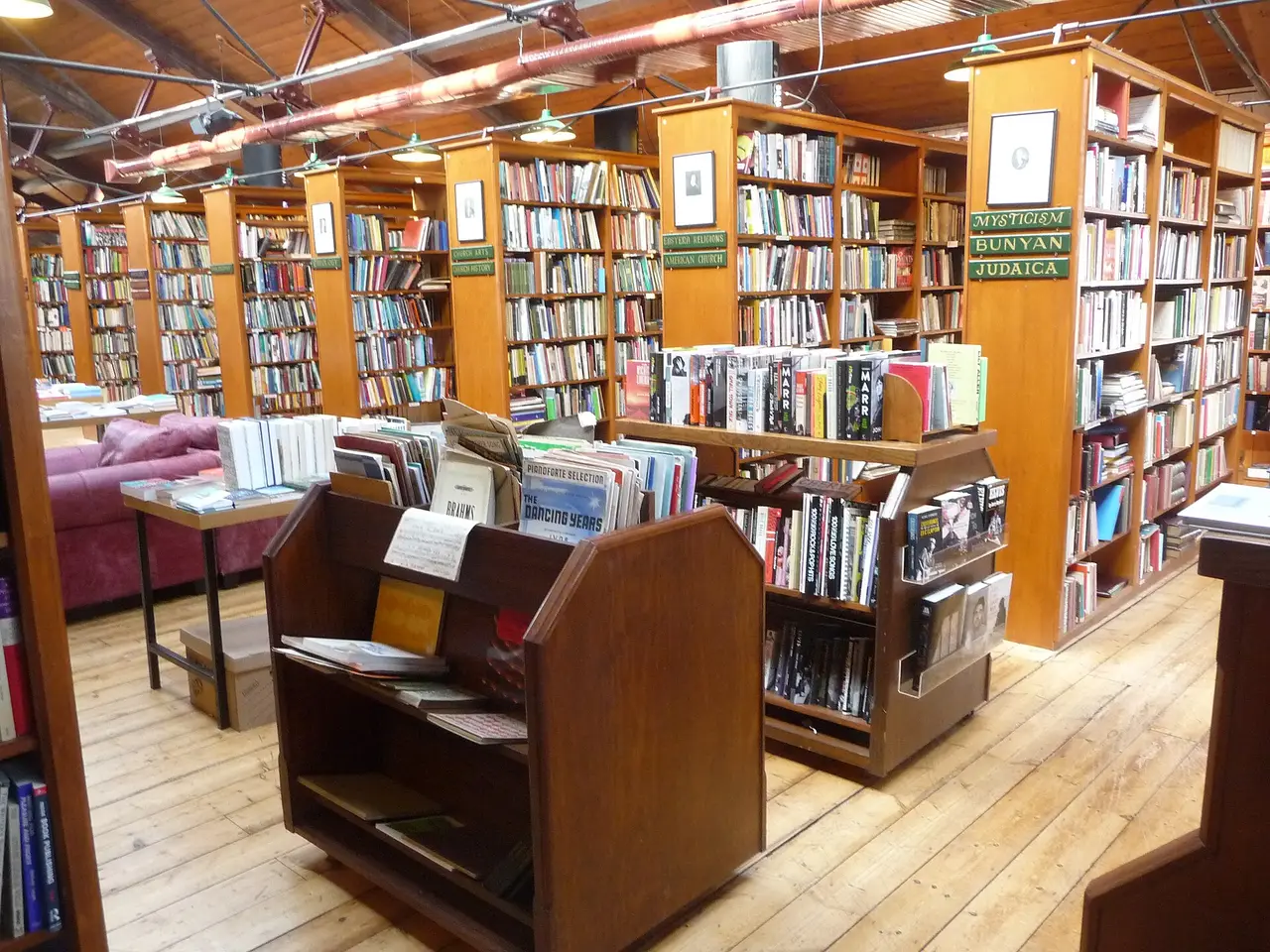 Tall wooden bookshelves filling a large bookshop