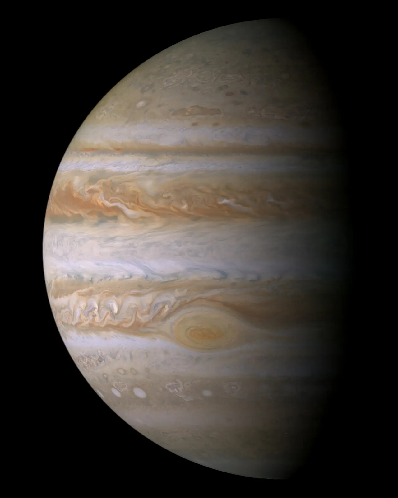 The planet Jupiter with banded clouds against black space