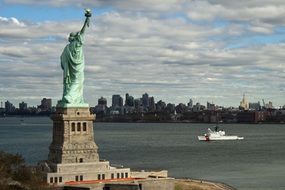 side view statue of liberty at new york city skyline, usa