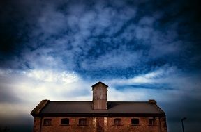 Cloudy sky over old warehouse