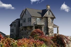 Natural stone country house on rock