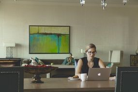 woman with laptop and cup of coffee