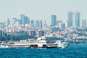 cruise ship with tourists in view of city at waterline, turkey, istanbul