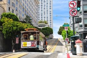 cable car on railroad at cityscape, usa, california, san francisco