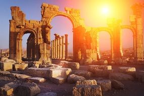 Monumental Arch of Palmyra ruins at sunset, syria